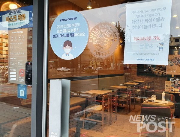 사회적 거리두기 2.5단계 지침을 준수해 운영하고 있는 프랜차이즈 카페. 매장 내 영업이 금지되면서 테이블과 의자 사용 금지를 알리는 줄을 걸쳐 놓았다. (사진=이상진 기자)